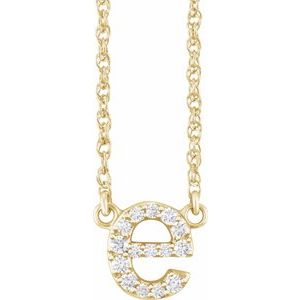 Gold initial E necklace encrusted with sparkling diamonds on a delicate chain.