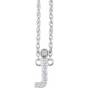 Diamond-encrusted letter J pendant on a silver chain necklace