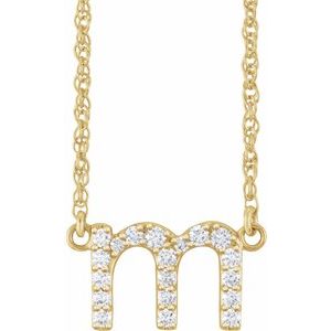 Gold initial M necklace featuring pavé-set diamonds on a delicate gold chain