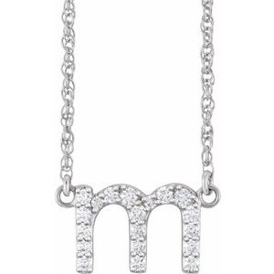 Silver letter M pendant necklace embellished with shimmering diamonds