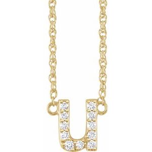 Gold initial U pendant necklace with pavé diamonds on a delicate chain.