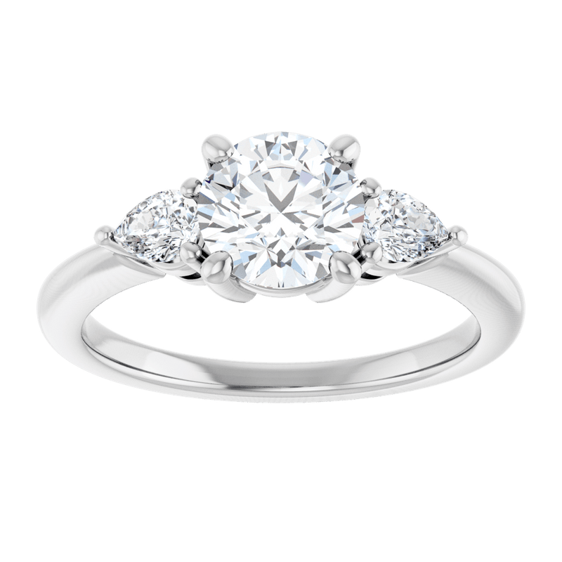 Three-stone diamond engagement ring in white gold with a large round center stone.