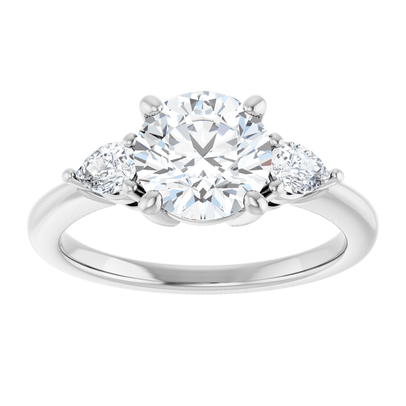Round cut lab-grown diamond engagement ring with pear side stones in a silver band