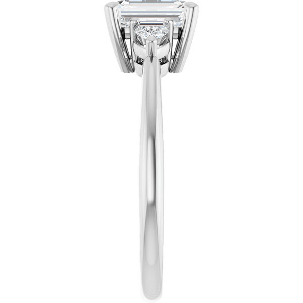 Side view of an emerald cut diamond ring in a white gold setting.