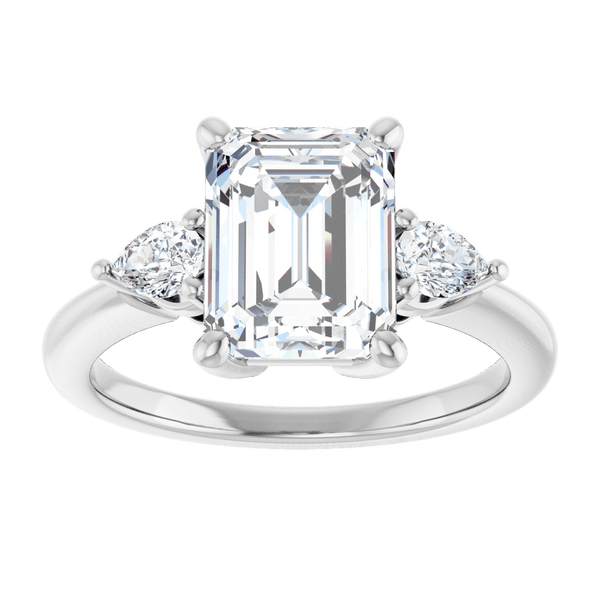 Emerald cut diamond engagement ring with side stones in white gold.
