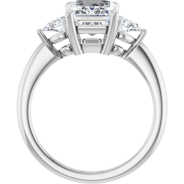 Three-stone diamond engagement ring in white gold with a central emerald cut diamond.