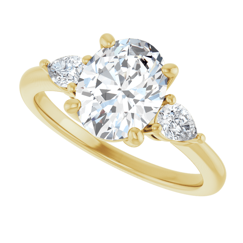 Oval lab-grown diamond engagement ring with pear-shaped side stones in yellow gold