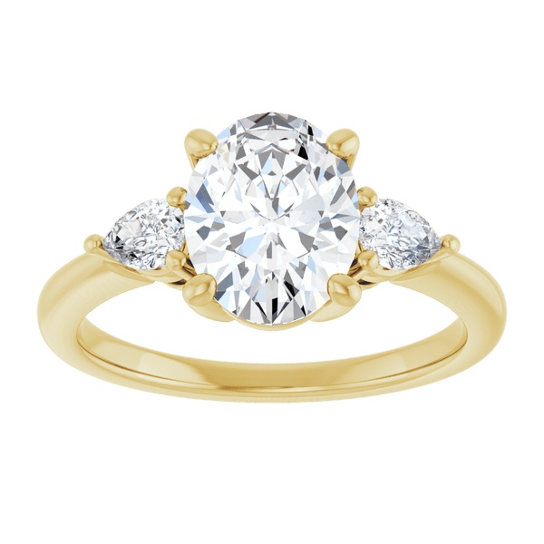Three-stone engagement ring with an oval center diamond and pear side diamonds in yellow gold