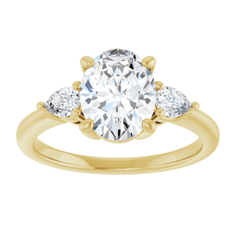 Three-stone engagement ring with an oval center diamond and pear side diamonds in yellow gold