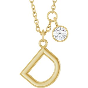 Gold pendant necklace featuring a diamond charm and a geometric letter D pendant.