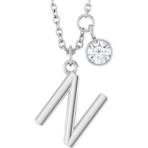 Silver letter N pendant necklace with a sparkling round diamond charm.