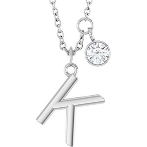 Silver initial K pendant necklace with a sparkling round diamond charm.