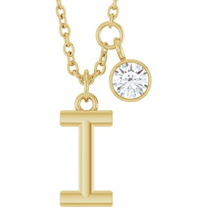 Gold initial T pendant necklace with a small round brilliant diamond charm