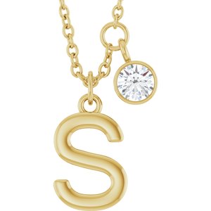 Gold initial S pendant necklace with a round brilliant cut diamond charm.