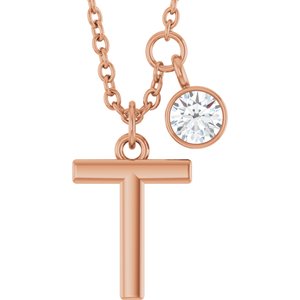Rose gold letter T pendant necklace with a sparkling round diamond charm.