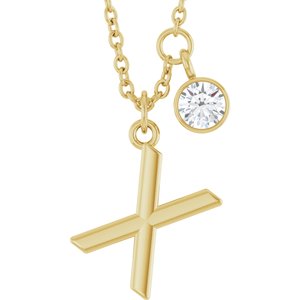 Gold letter X pendant necklace with a sparkling round diamond charm.