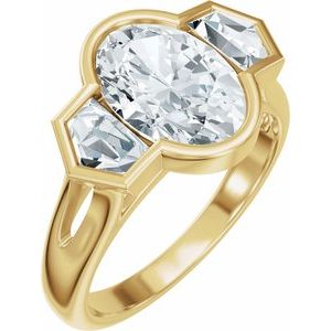 Three-stone lab-grown diamond ring with an oval center stone in a yellow gold setting