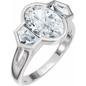 Oval-cut lab-grown diamond engagement ring with side stones in a polished silver band