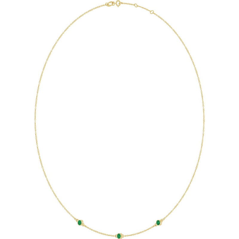 Fine gold chain necklace featuring three small round green gemstones