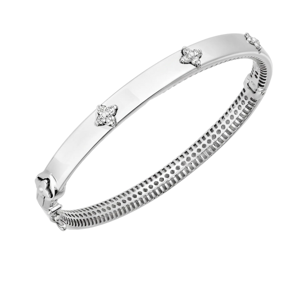 A polished silver-toned bangle bracelet with three small diamond-like floral accents spaced along the outer band, shown on a plain white background.