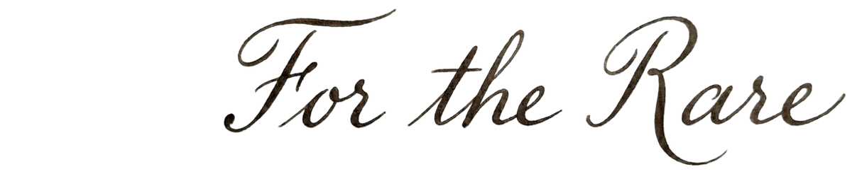 Elegant cursive calligraphy text reading 'For the Rare' in a dark brushstroke style.