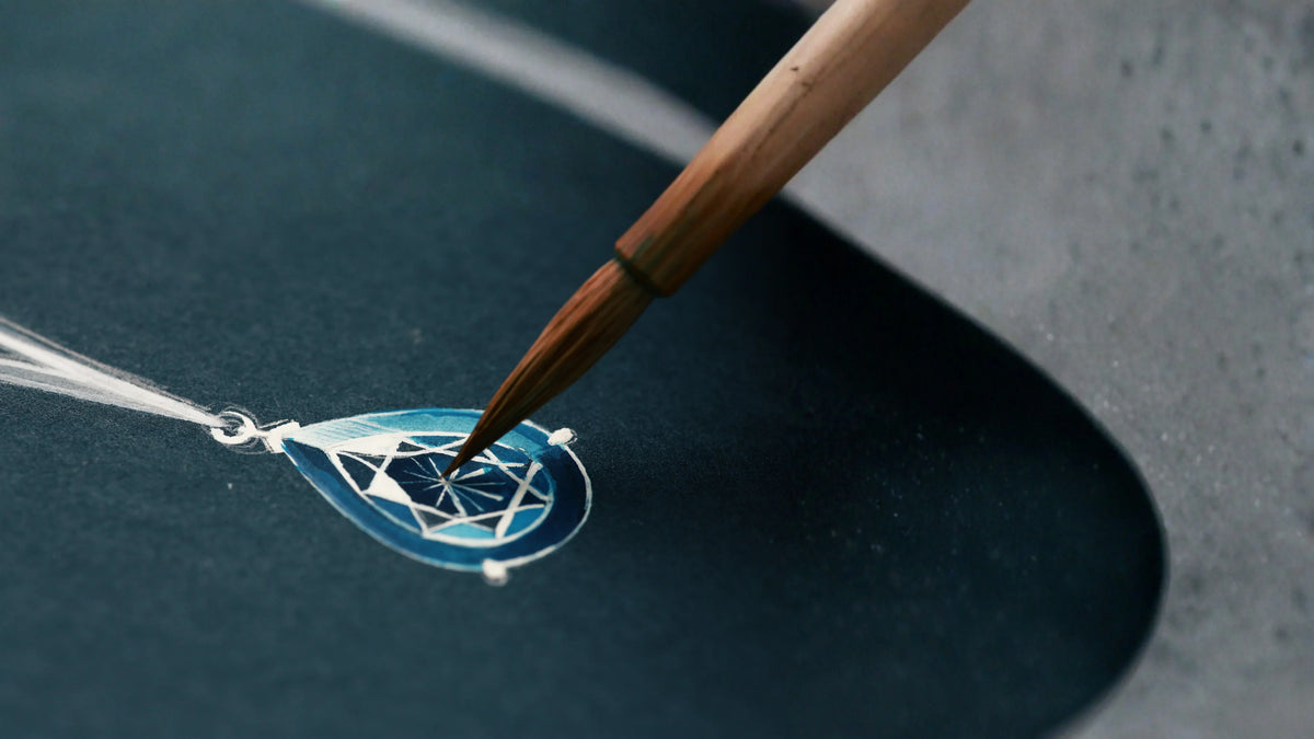 Hand-painted blue teardrop pendant design with diamond facet details using a fine brush.