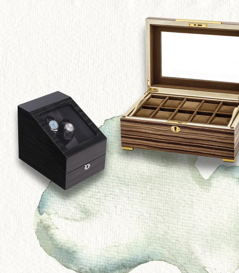 Luxury wooden watch box with two watches and an open multi-slot watch organizer.