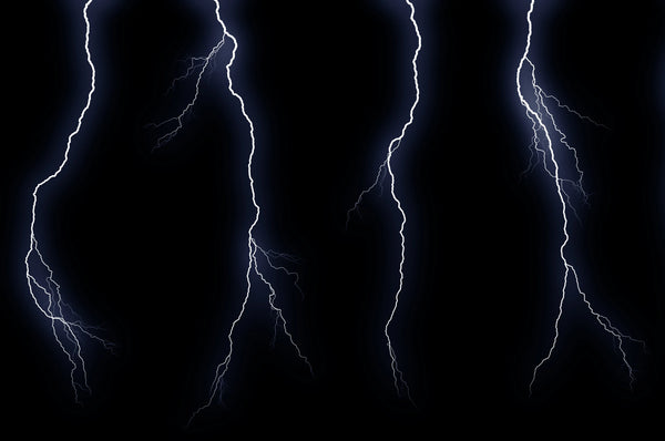 Multiple bright white lightning bolts striking against a dark black night sky.